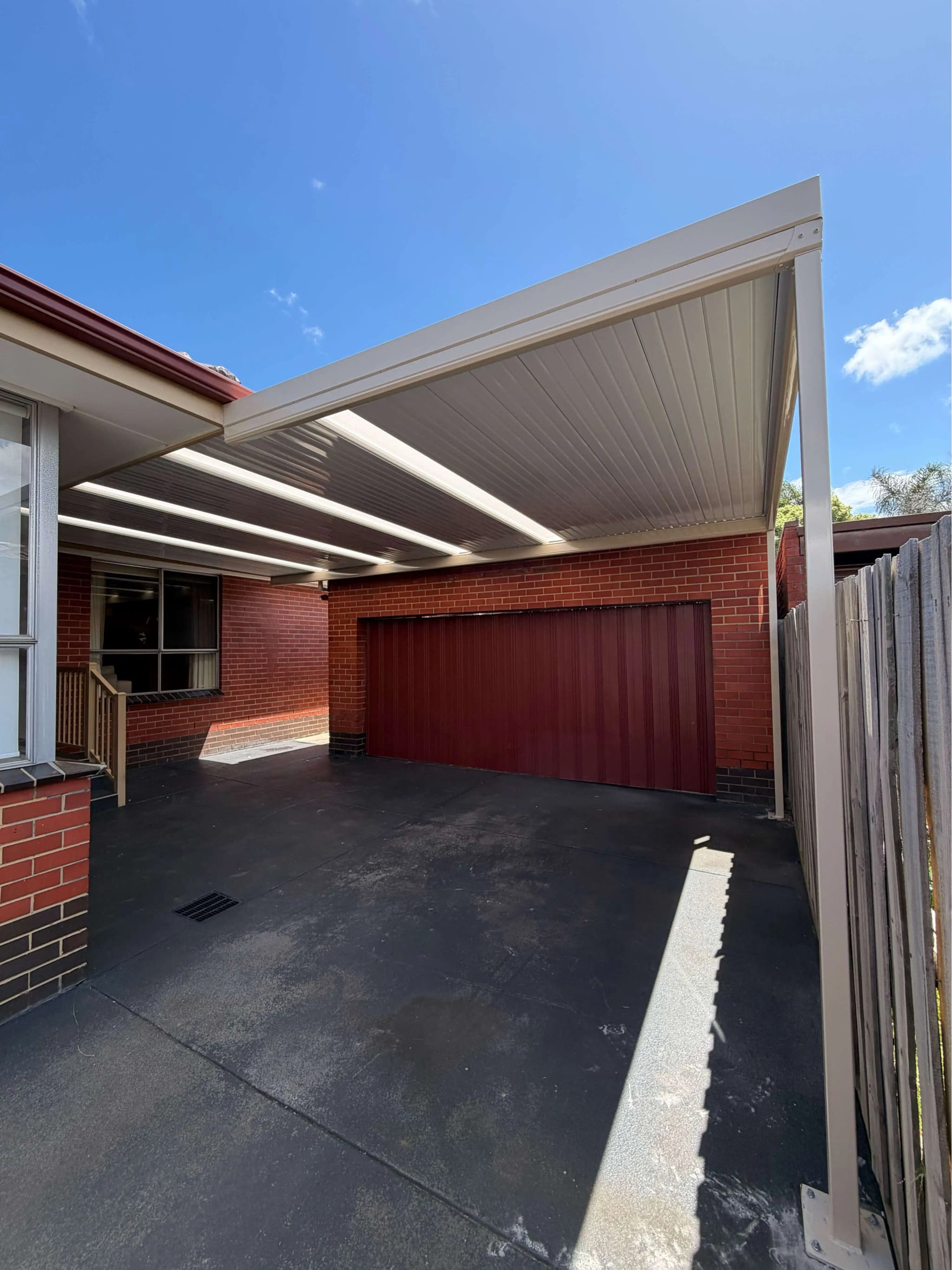 Skillion carport with brick home